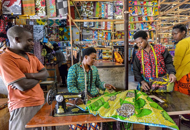 A seamstress making a dress in the Kimironko market