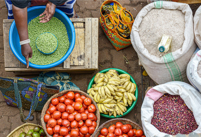 A woman selling fruit in the market Huye in Rwanda