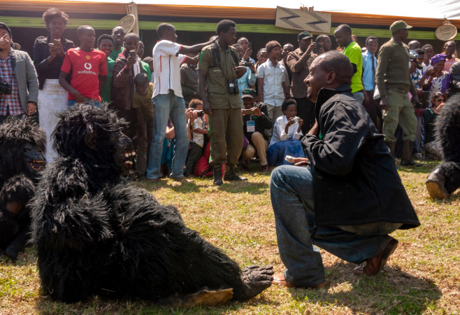 Men in Gorilla costumes and the visitors at Kwita Izina (Gorilla Naming Ceremony)